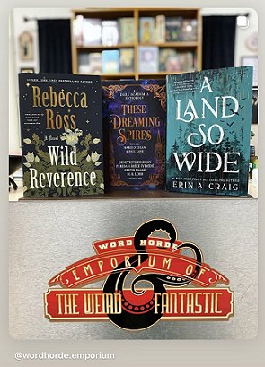 screenshot from @wordhorde.emporium showing a copy of These Dreaming Spires, edited by Marie O'Regan and Paul Kane, standing on a dark surface between two other books - Wild Reverence by Rebecca Ross on the left, and A Land So Wide by Erin A. Craig on the right