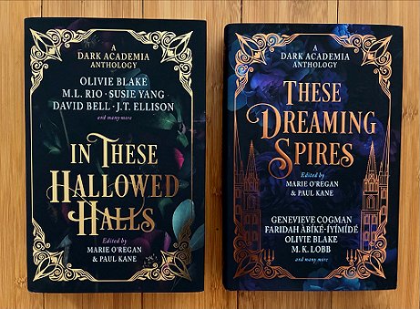 photograph of a copy of In These Hallowed Halls (left) and These Dreaming Spires (right), both edited by Marie O'Regan and Paul Kane, lying on a wooden surface
