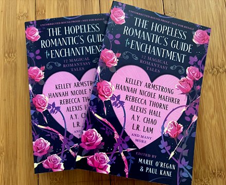 photograph showing two copies of The Hopeless Romantic's Guide to Enchantment, edited by Marie O'Regan and Paul Kane, lying on a wooden surface