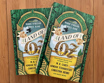 photograph of two copies of Land of Oz, edited by Marie O'Regan and Paul Kane, on a wooden surface