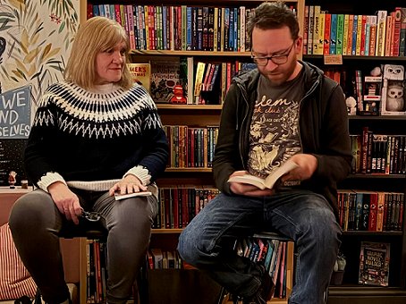 L: Marie O'Regan watching Mark A. Latham read from The Last Vigilant