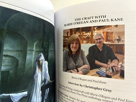 photograph of copy of Phantasmagoria #28, held open to show a photograph of Marie O'Regan and Paul Kane. Heading: The Craft with Marie O'Regan and Paul Kane. Text under the image reads: Interview by Christopher Gray