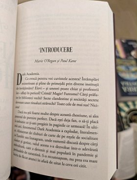 photograph of a copy of the Romanian edition of In These Hallowed Halls, edited by Marie O'Regan and Paul Kane, being held open to show the Introduction page
