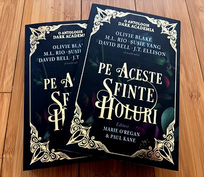 photograph showing two copies of the Romanian edition of In These Hallowed Halls, edited by Marie O'Regan and Paul Kane, on a wooden surface
