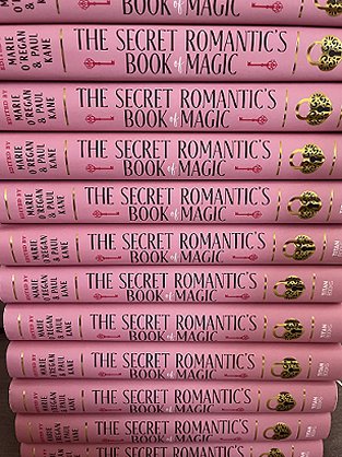 photograph showing a pile of copies of The Secret Romantic's Book of Magic, edited by Marie O'Regan and Paul Kane, to show the books' spines